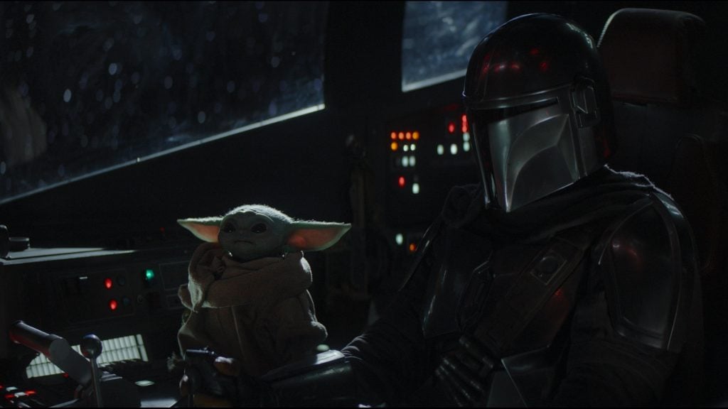 The Mandalorian sitting with The Child