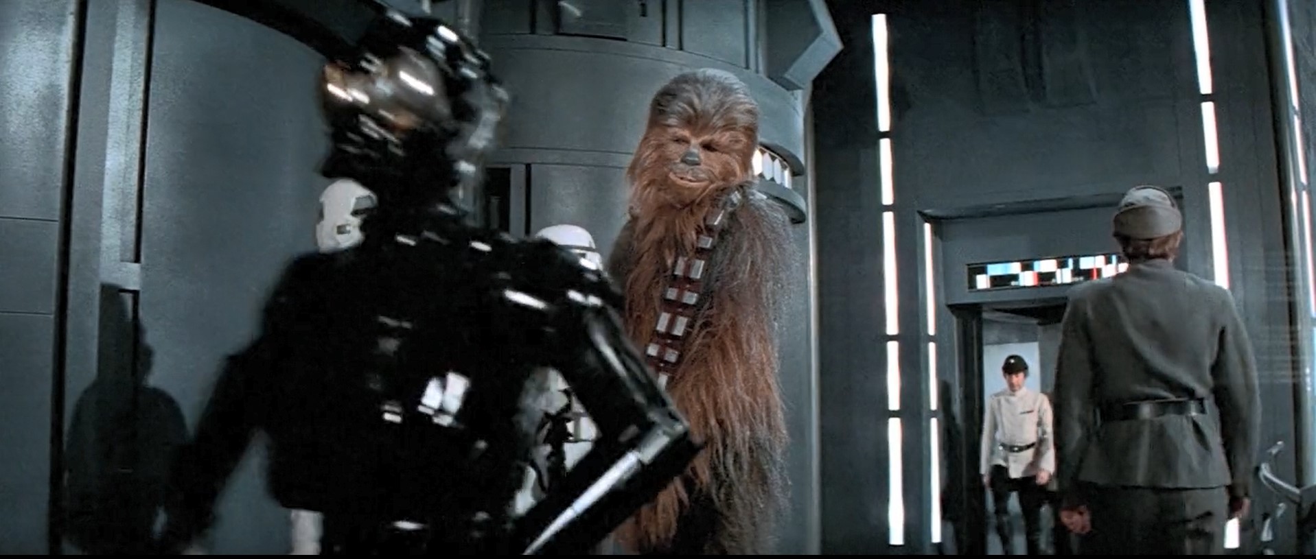 Black Death Star Droid walks past Luke, Han and Chewie on Death Star. Black droid prop.