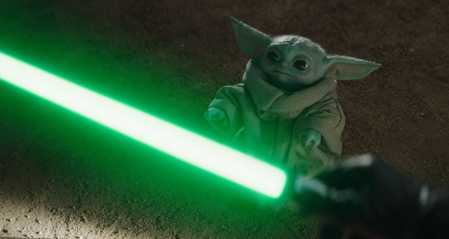 Grogu looks at Yoda's lightsaber in The Book of Boba Fett