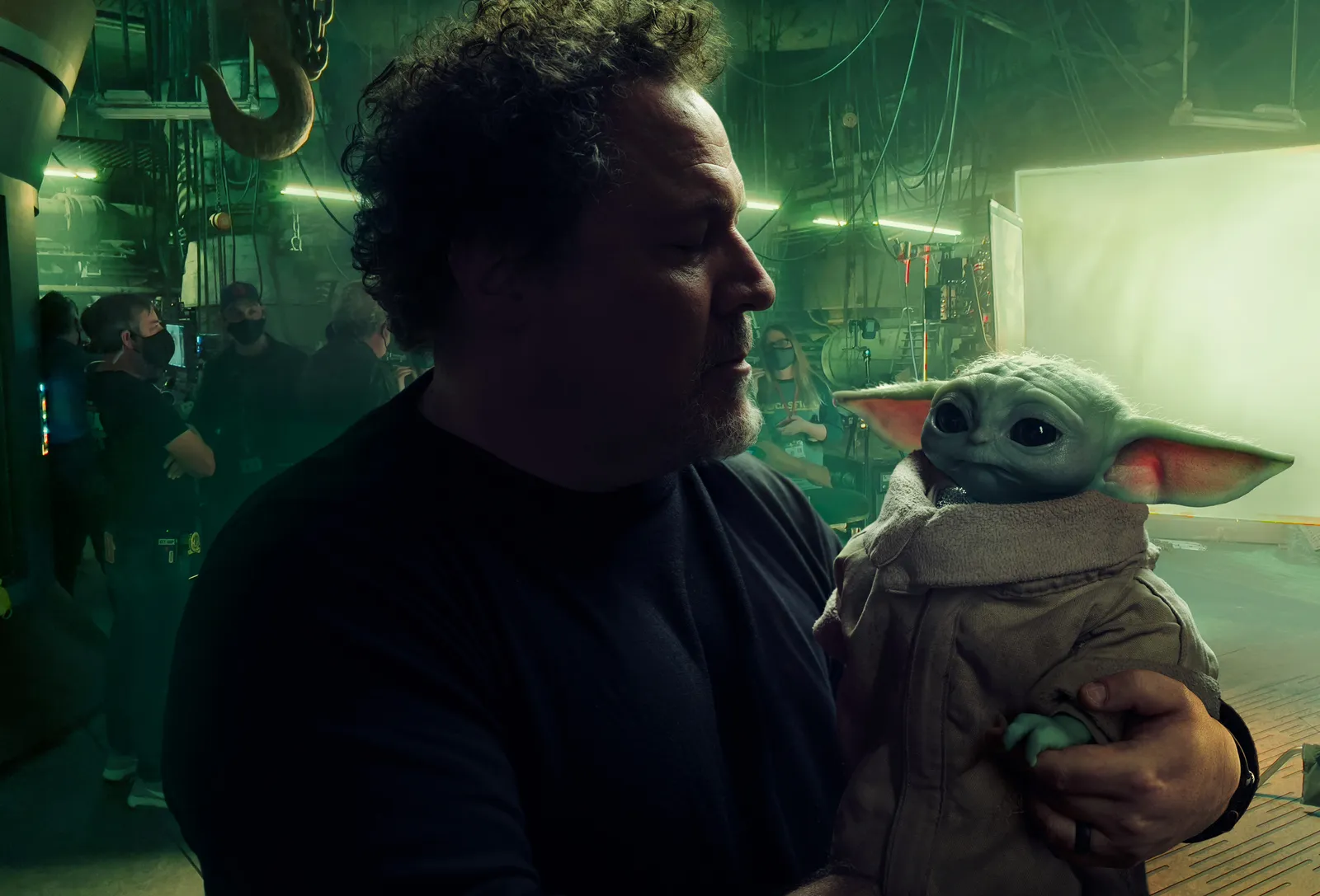 Jon Favreau with Grogu from Star Wars: The Mandalorian